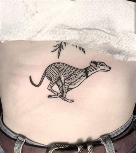 Running dog tattoo by Mikes Shaw inked on the center of the belly ...