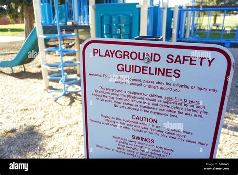 Sign in front of playground showing playground safety guidelines and rules Stock Photo - Alamy