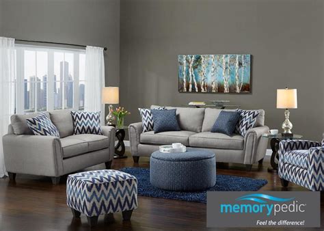a living room with gray furniture and blue accents