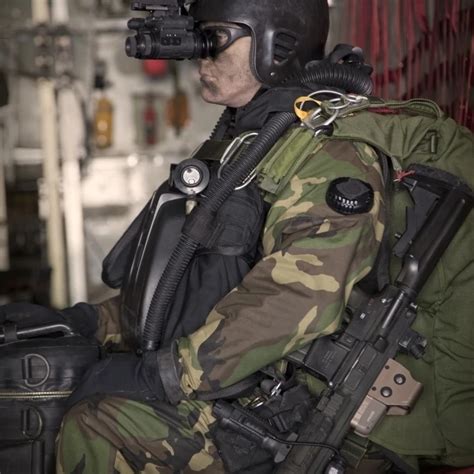 U.S. Navy Seal equipped with night vision prepares for HALO jump ...