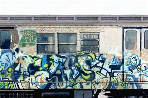 a train car covered in graffiti sitting on the tracks