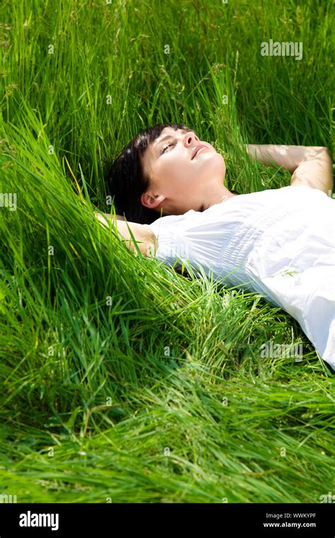 beautiful girl lying down of grass. Copy space Stock Photo - Alamy