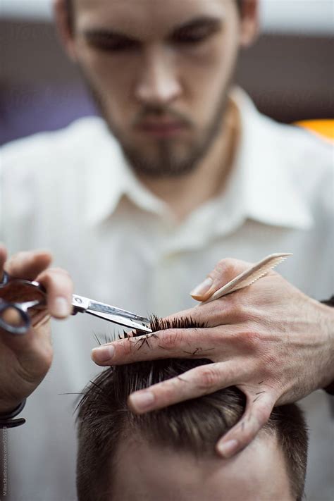 "Barber Cutting Hair To A Client" by Stocksy Contributor "Milles Studio" - Stocksy