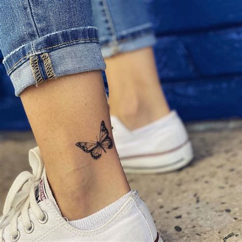 Fine line butterfly tattoo on the ankle