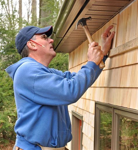 Carpenter Installing Cedar Shingles Stock Image - Image: 8967701