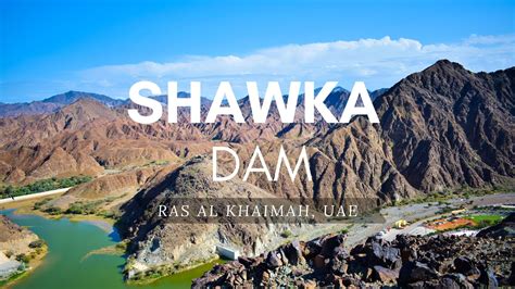 the words shawka dam are in front of mountains and lakes with green water