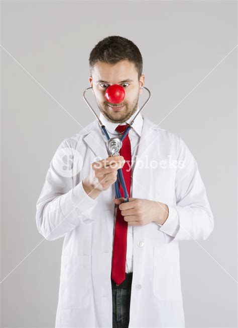 Portrait of funny doctor with red nose Royalty-Free Stock Image - Storyblocks