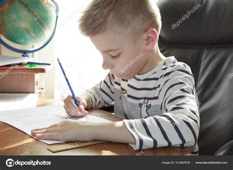 Boy is doing math homework Stock Photo by ©sommersby 312467618