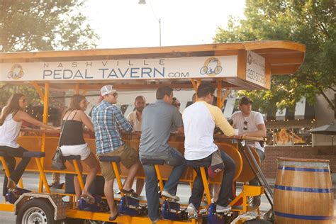 a group of people riding on the back of a yellow cart