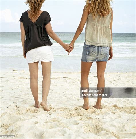 Two Women Holding Hands At Beach Rear View High-Res Stock Photo - Getty ...