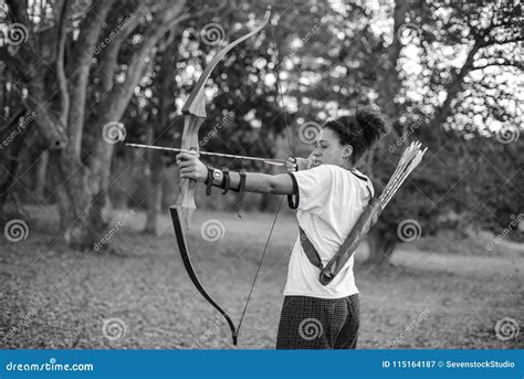 A Girl Aiming Bow and Arrow in the Forest Stock Image - Image of ...