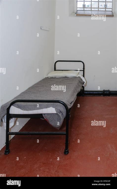 Bed in a small jail cell Stock Photo - Alamy