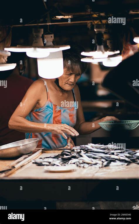 An Old Filipino Vendor Selling Fish in the Philippines Stock Photo - Alamy