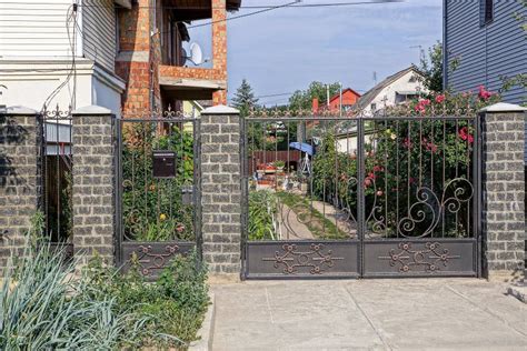 Black Iron Gate with a Forged Pattern and Part of a Fence Stock Photo ...