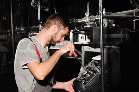 The lighting engineer adjusts the lights on the stage | Stock image | Colourbox