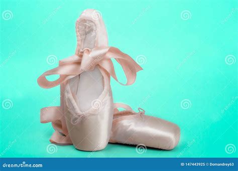 Pointe Shoes Ballet Dance Shoes with a Bow of Ribbons Beautifully Folded on a Green Background ...