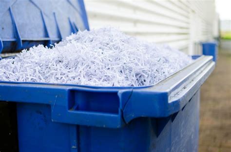 Blue whelie bin full of shredded paper - Global Document Services, LLC