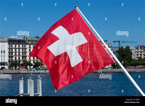 The Swiss flag, flag of Switzerland, flying over Lake Geneva / Lac ...