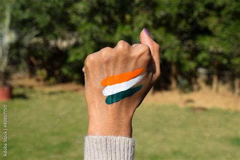 Indian flag tattoo of tri colour painted on person's hand cheering and celebrating Indian ...