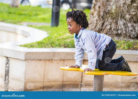 One Young Black Children Enjoy Time Having Fun at the Playground in ...