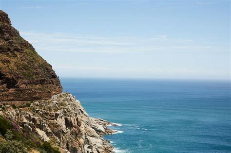 Rocky cliff on shore of sea · Free Stock Photo