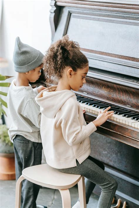 Focused black children playing piano together at home · Free Stock Photo