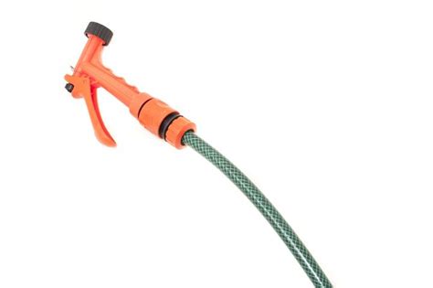 Free Image of Green plastic garden hose and orange nozzle | Freebie.Photography