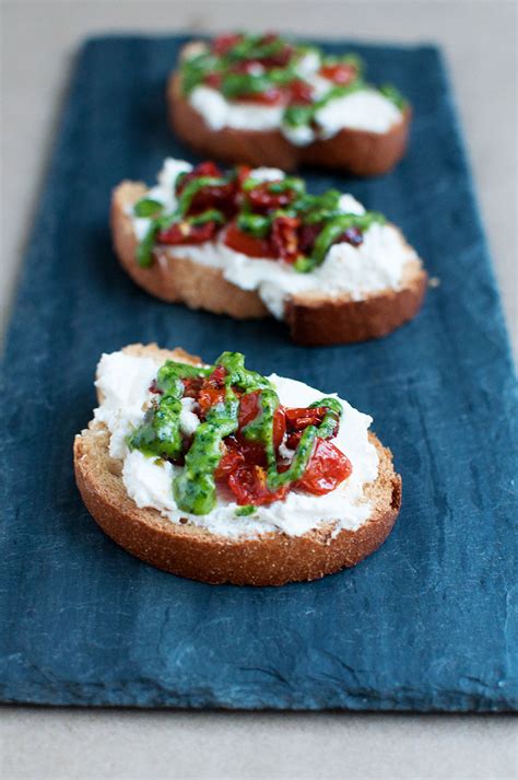 Roasted Tomato Crostini with Basil Pesto - Pretty in Pistachio