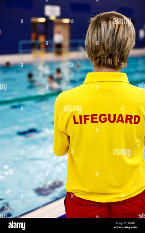 Female lifeguard watching swimmers at an indoor swimming pool in the UK Stock Photo - Alamy