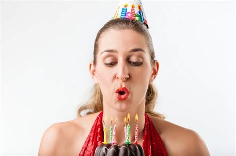 Premium Photo | Woman celebrating birthday with cake blowing candles out