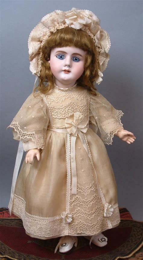 an antique doll is standing on a table