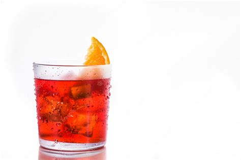 Premium Photo | Negroni cocktail with piece of orange in glass isolated ...