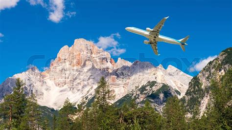 Airplane overflying mountains | Stock image | Colourbox