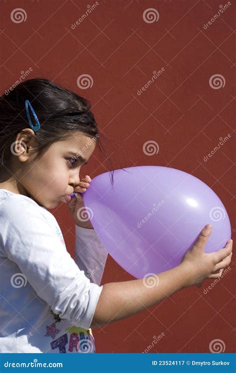 Girl blowing up balloon stock image. Image of cheerfulness - 23524117