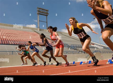 Group of female track athletes sprinting Stock Photo - Alamy