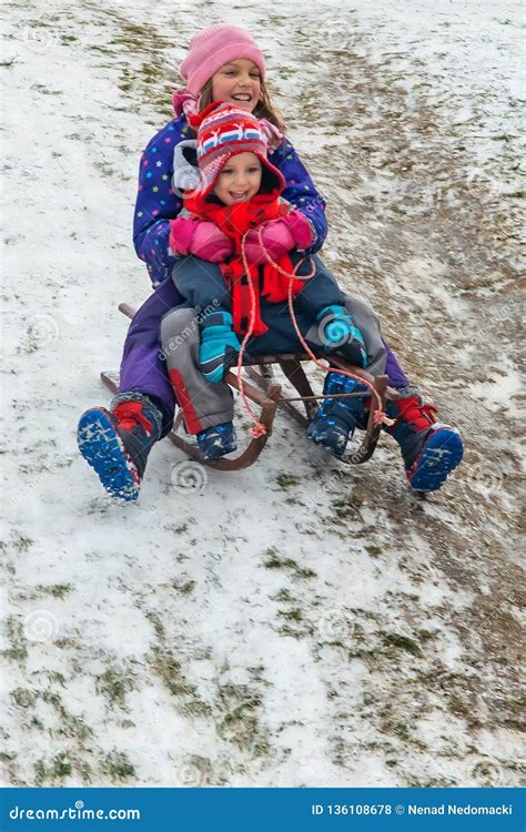 Children Enjoy Snowshoeing in the Snow Park Where the Grass Comes Out Stock Photo - Image of ...