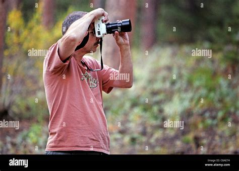 A photographer taking photos in Rocky Mountain National Park. Shot on Fuji 200 film Stock Photo ...