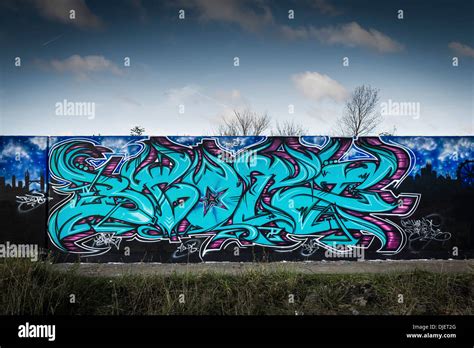 A concrete wall covered in Graffiti Stock Photo - Alamy