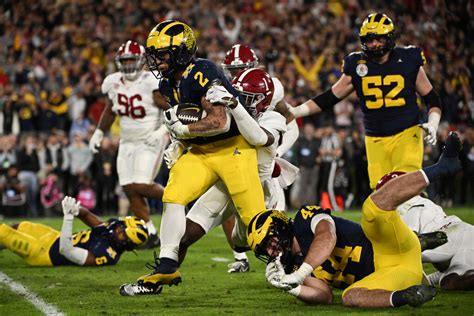 Michigan beats Alabama 27-20 in overtime on Blake Corum's TD run to reach national title game ...