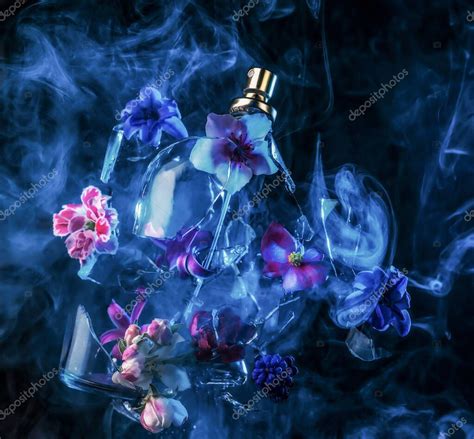A glass perfume bottle shatters and bright spring flowers and clouds of blue and purple vapor ...