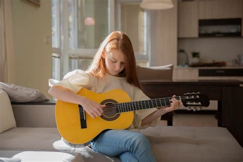 Premium Photo | Cute little girl playing guitar