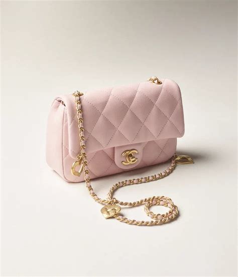 Chanel's Gorgeous New Mini Flap Bag Is Pink & Comes With Heart-Shaped Charms On Its Chain