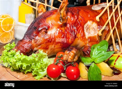 roasted pig with herbs and vegetables Stock Photo - Alamy