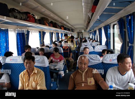 Passengers on a hard seat train from Qingdao to Shanghai China Stock Photo - Alamy