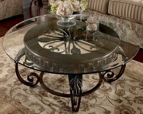 Clear Round Glass Top Coffee Table With Ornate Brown Base Placed In A ...