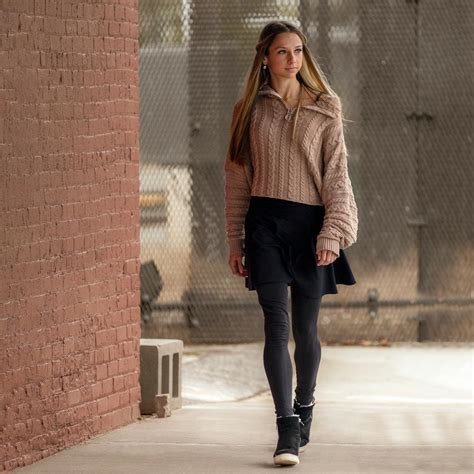 Stylish woman walking on sidewalk near building · Free Stock Photo