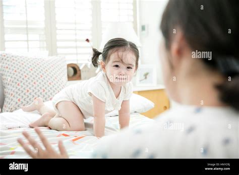 Baby girl smiling at mother Stock Photo - Alamy