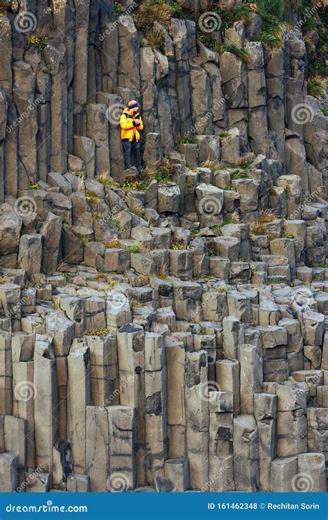 REYNISFJARA BLACK BEACH, ICELAND, 24 OCTOBER 2019: Tourist on the Basalt Columns of the Black ...