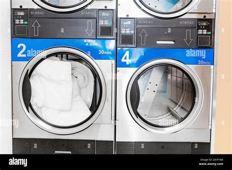 industrial laundry machines in laundromat Stock Photo - Alamy