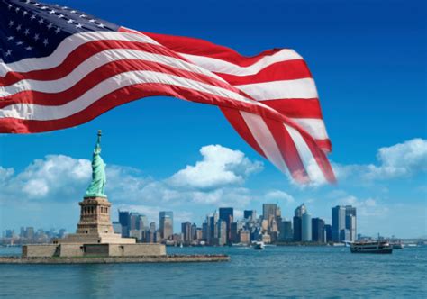 Us Flag And Statue Of Liberty With New York Behind Stock Photo - Download Image Now - iStock